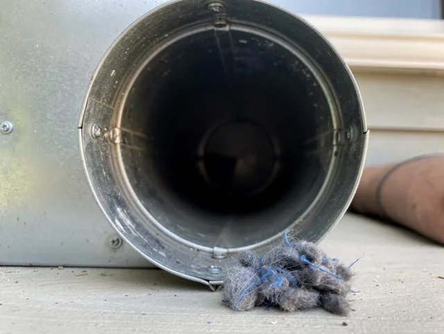 Parma Dryer Vent Cleaning technician using specialized equipment to clear severe dryer vent blockage in Parma